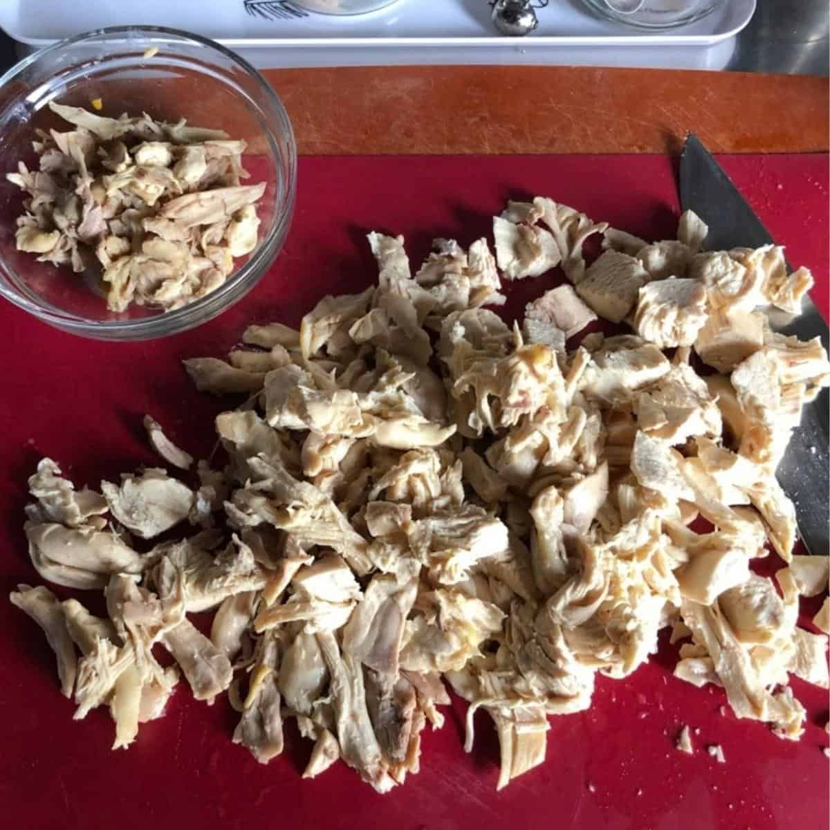 Deboned chicken pulled into pieces ready to add back to the soup for homemade chicken and dumpling soup.