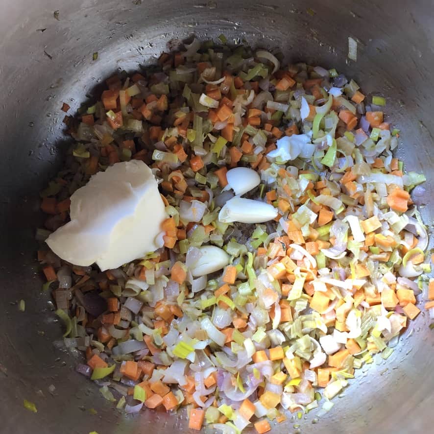 diced shallots, leeks and carrots in a large pot with butter, sage and rosemary