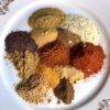 Shawarma spice blend on a plate in individual mounds not yet mixed together