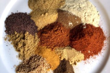 Shawarma spice blend on a plate in individual mounds not yet mixed together