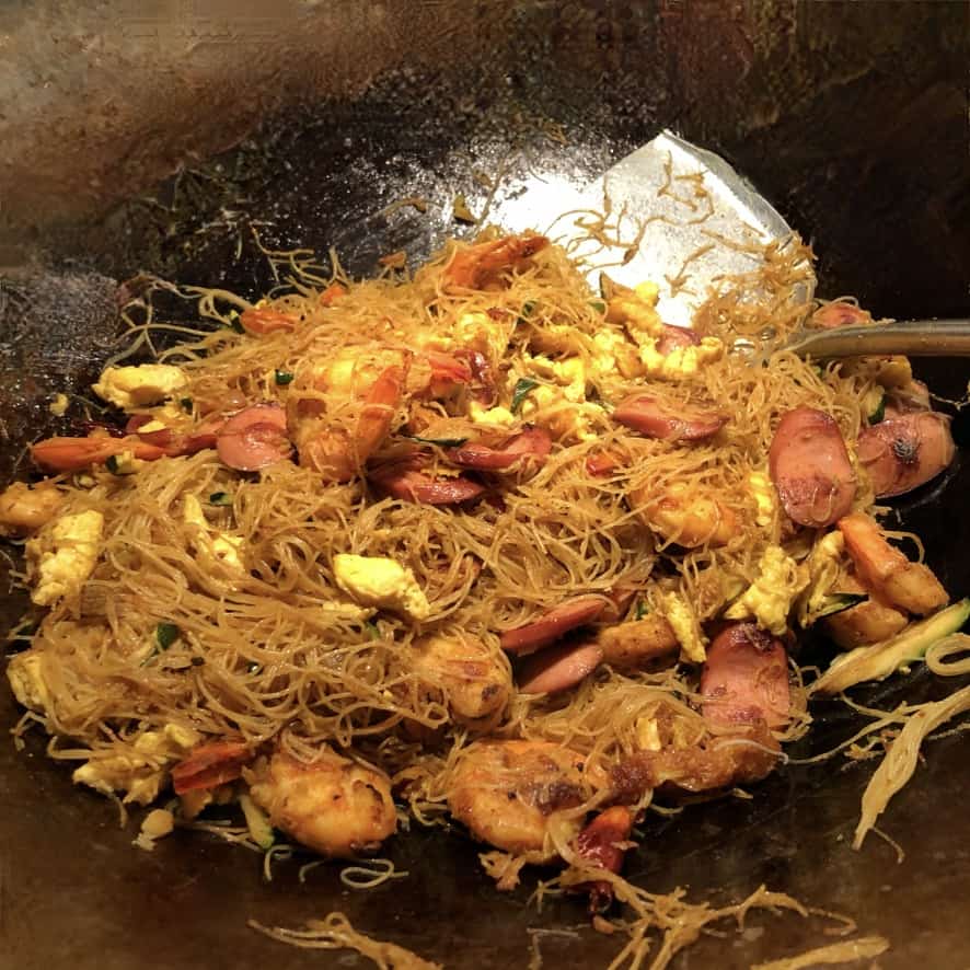 a wok full of singapore shrimp and pork mei fun noodles