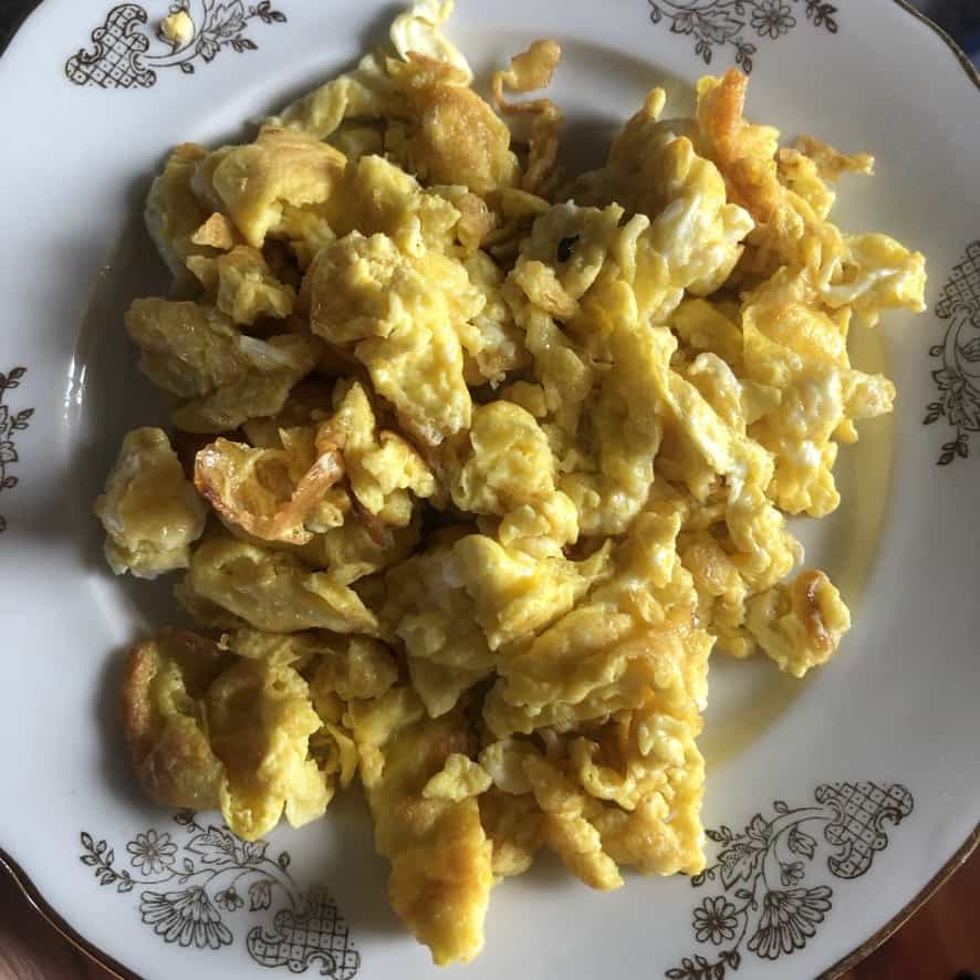 stir fried egg pieces on a plate to cool