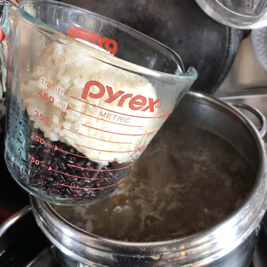 adding the first 2 cups of rice to the soup