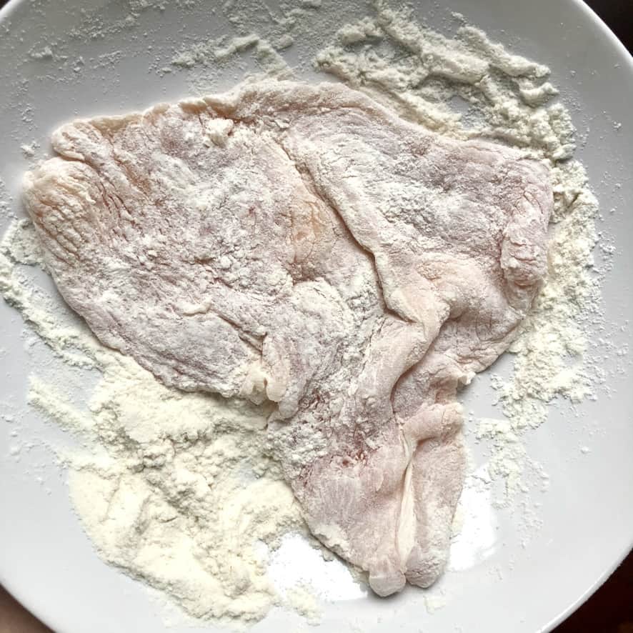 turkey breast cutlet completely covered with flour