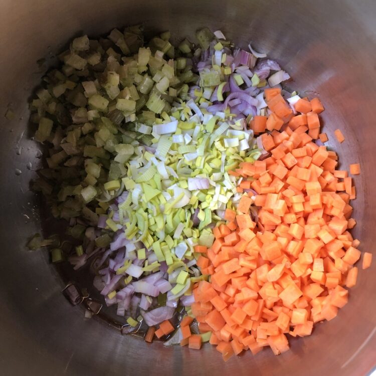 diced shallots, leeks and carrots in a large pot