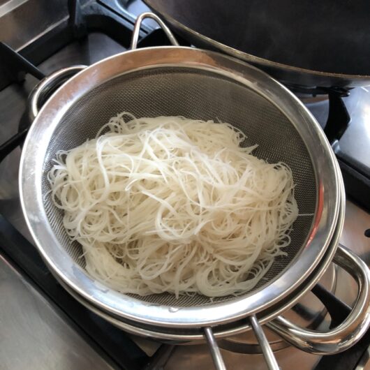 strained vermicelli noodles in a sieve