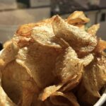 homemade potato chips in a bowl in the sun