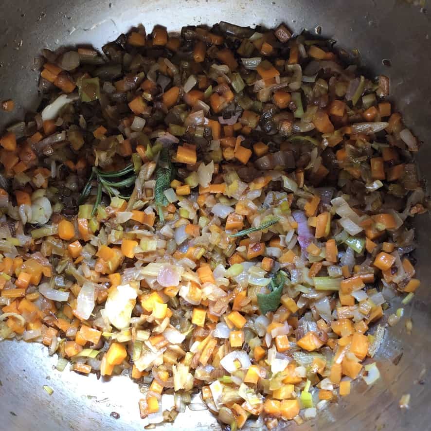 diced shallots, leeks and carrots in a large pot with butter, sage and rosemary