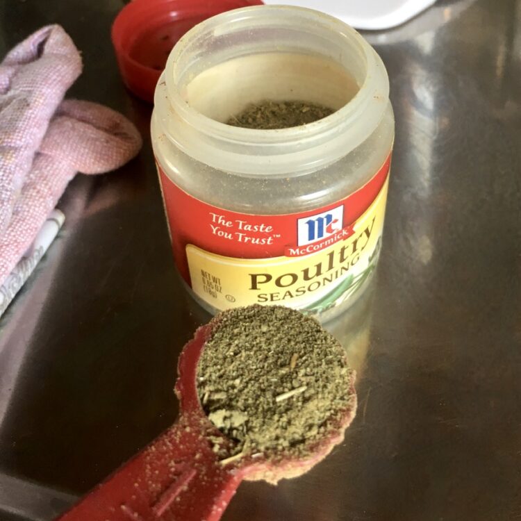 a small container of McCormick's poultry seasoning with a small amount in a measuring spoon