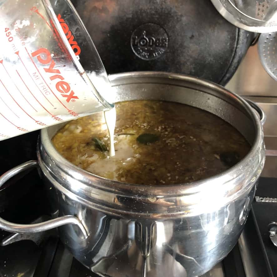 adding cream to turkey soup