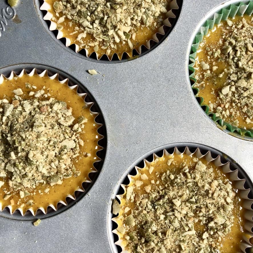 unbaked pumpkin muffins topped with pumpkin seed crunch