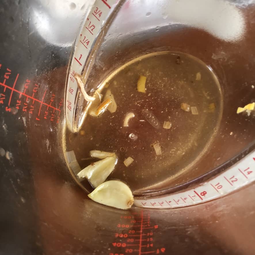 smashed garlic cloves removed from the soup to a measuring cup