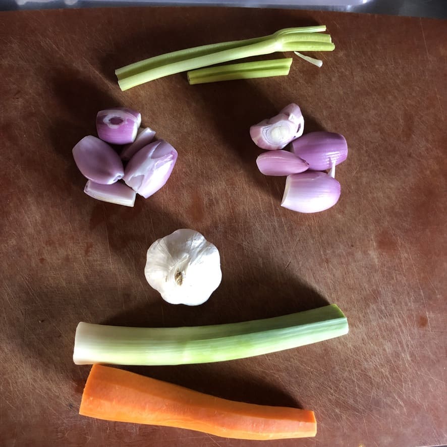 vegetables on a cutting board in the shape of a face