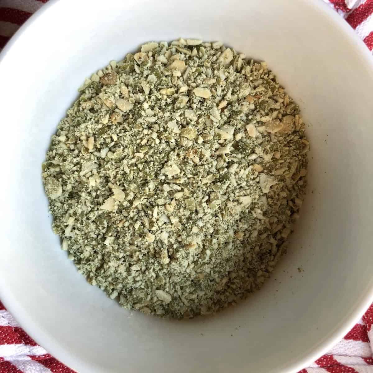 Chopped raw pumpkin seeds ready to be used as a topper for pumpkin muffins. 

