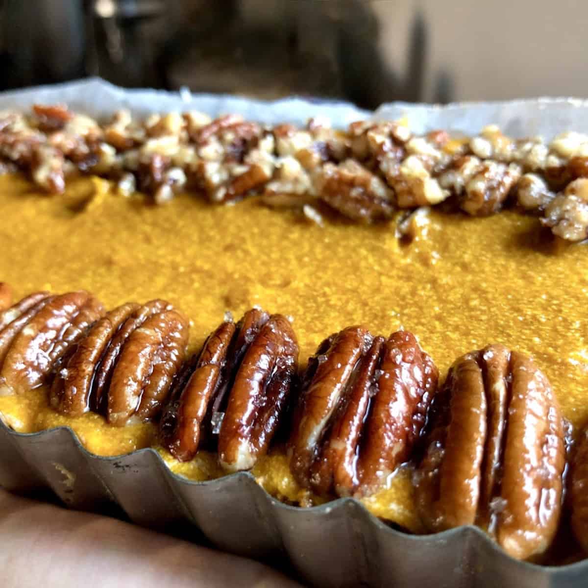 A pumpkin tart with a pecan crunch topper showing an alternative crunch topping for tarts and muffins.
