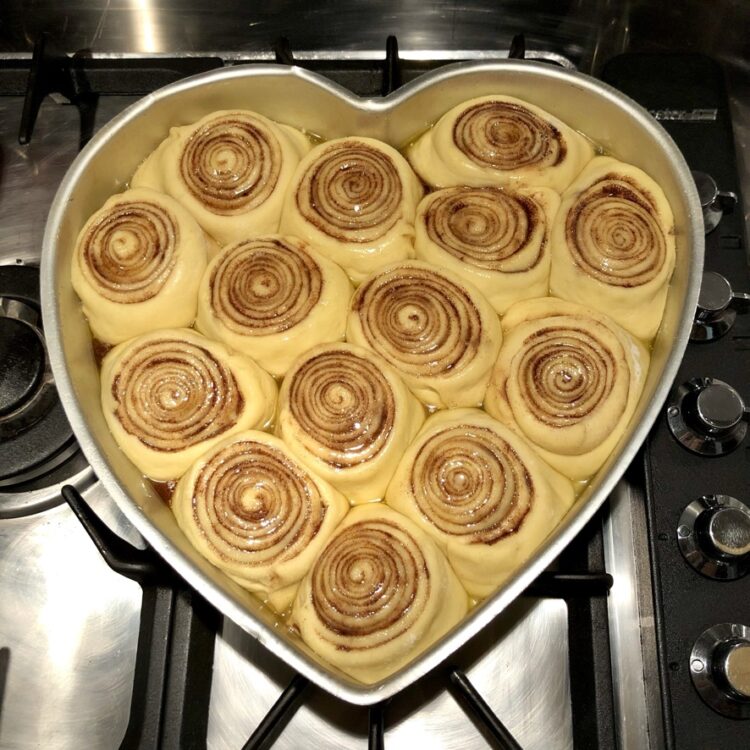 fully risen puffy cinnamon rolls ready to be baked