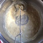 a whisk being used to stir the roux