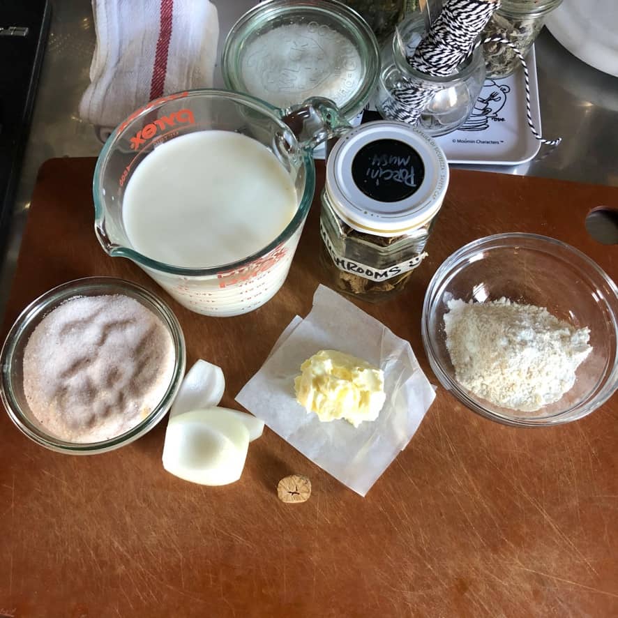 Porcini béchamel sauce ingredients on a cutting board