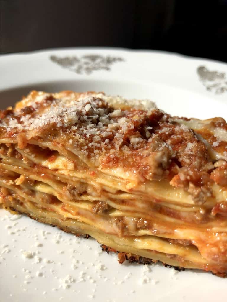 lasagna slice showing the interior layers with gooey cheese and tomato sauce