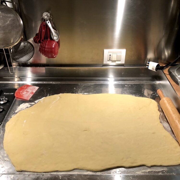 cinnamon roll dough rolled out into a rectangle