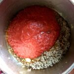 bright red La Giara Tomato Passata added to the beef and white wine mixture