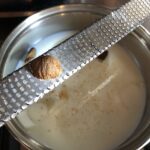 grating nutmeg into the milk mixture