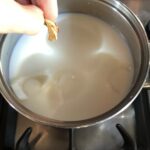 adding the dried porcini to the milk and onion mixture