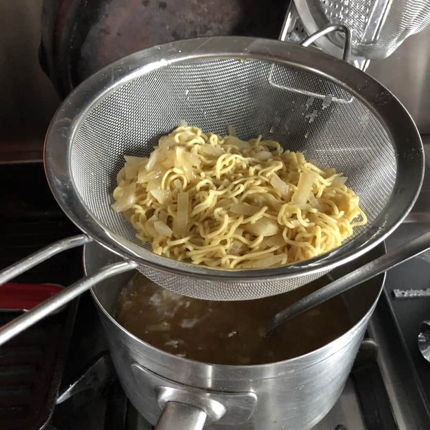 straining homemade egg noodles