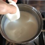 adding a chunk of onion to the milk