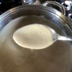 showing how the bechamel should coat the back of a spoon