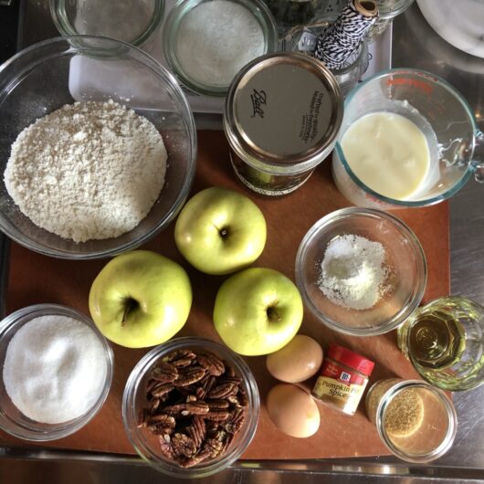 all of the ingredients used to make the apple rum cake on a cutting board on my kitchen countertop