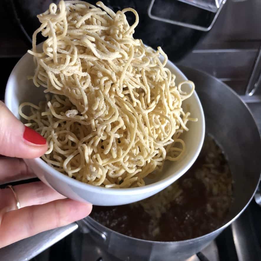 adding the egg noodles right in the chicken soup base