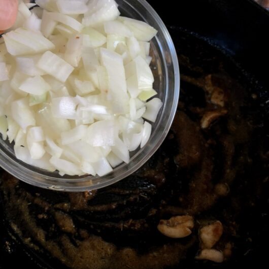 adding onions to the skillet