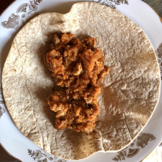 turkey tinga meat in a warmed whole wheat soft tortilla