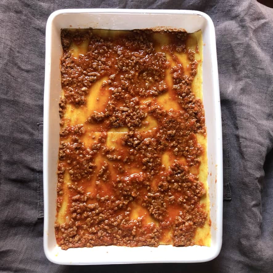 the ragù all spread out across the lasagna sheets