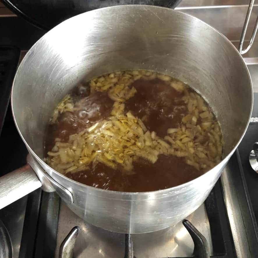a concentrated chicken soup base full of flavor brought to a rolling boil