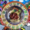 homemade chipotle in adobo sauce just mixed in a glass bowl sitting on top of a brightly painted terra cotta Mexican artwork plate