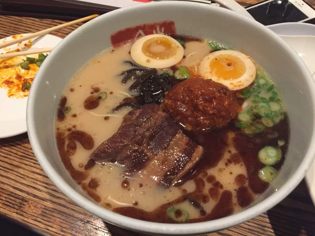 A bowl of ramen with custardy (not quite jammy) ramen eggs floating in the broth)