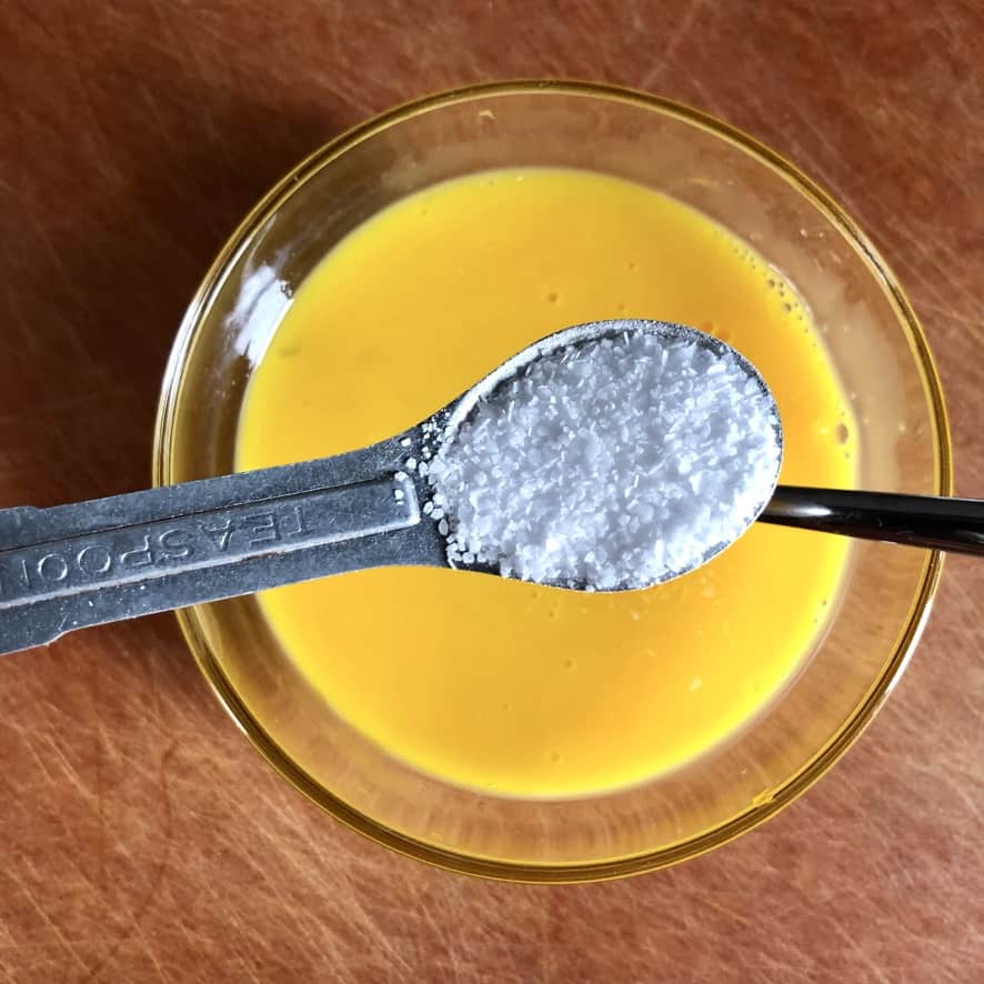 adding 1 teaspoon of kosher salt to the whisked eggs