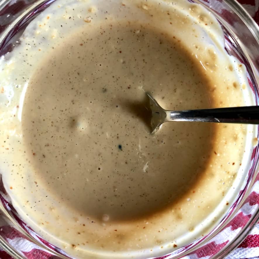 Soy-sesame mayonnaise in a small prep bowl with a spoon