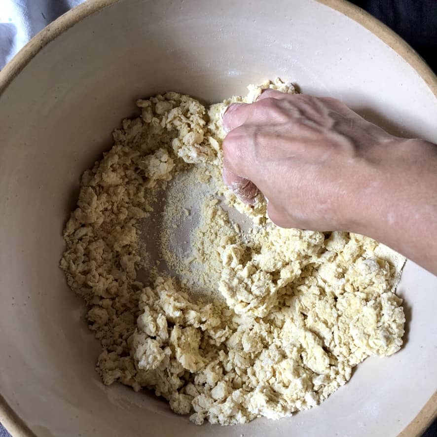 mixing the flour-egg mixture with y hands