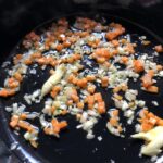 shallots, carrots, and garlic cooking in olive oil