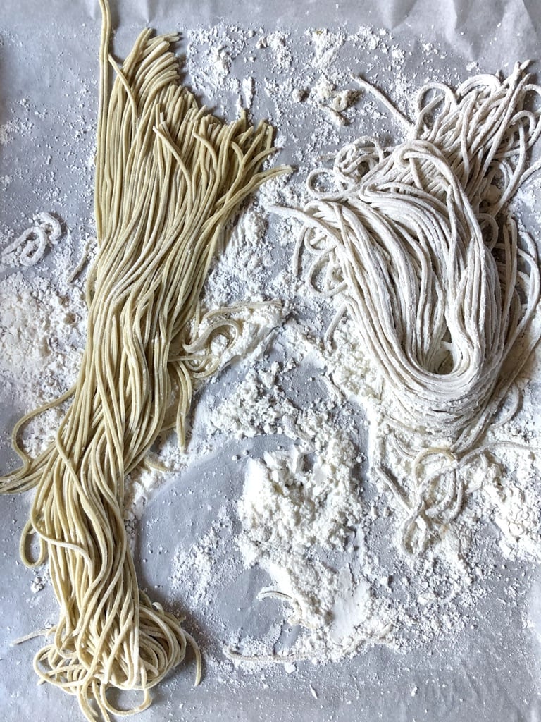 homemade alkaline ramen noodles on a sheet tray with cornstarch