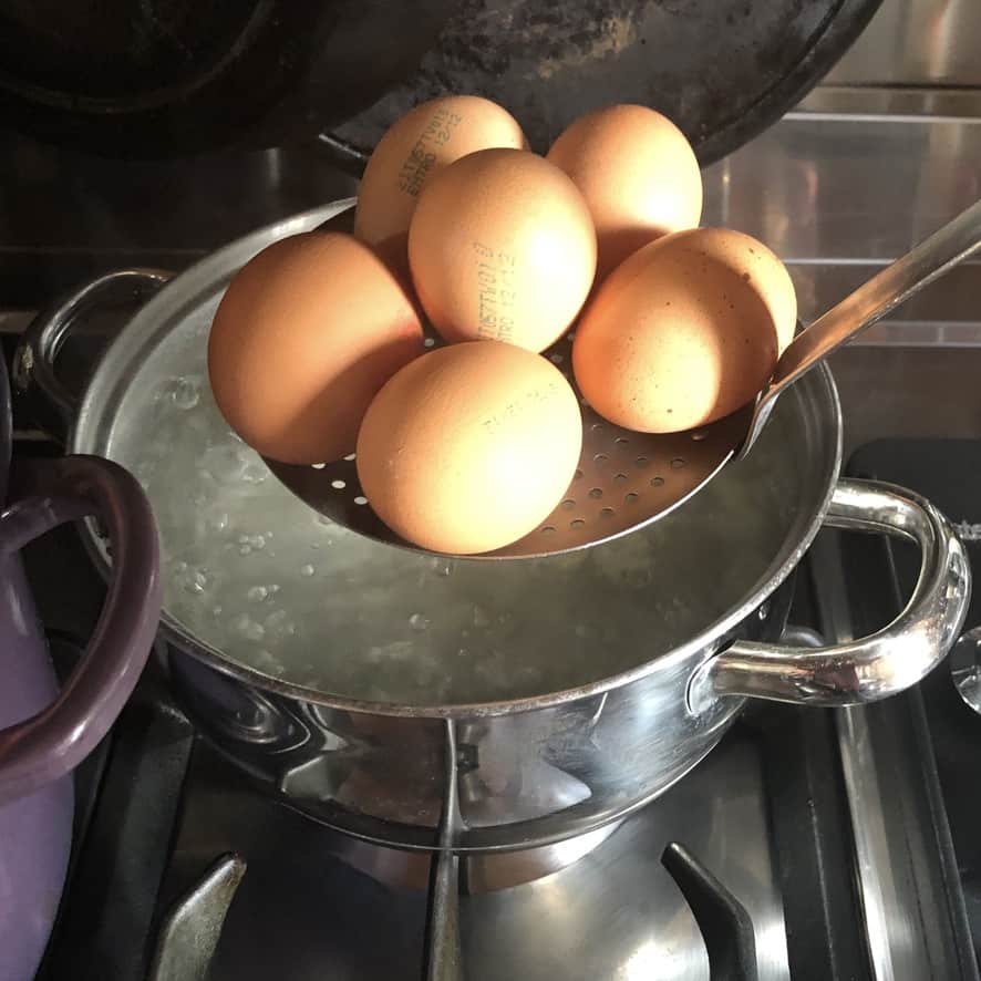 adding eggs to boiling water