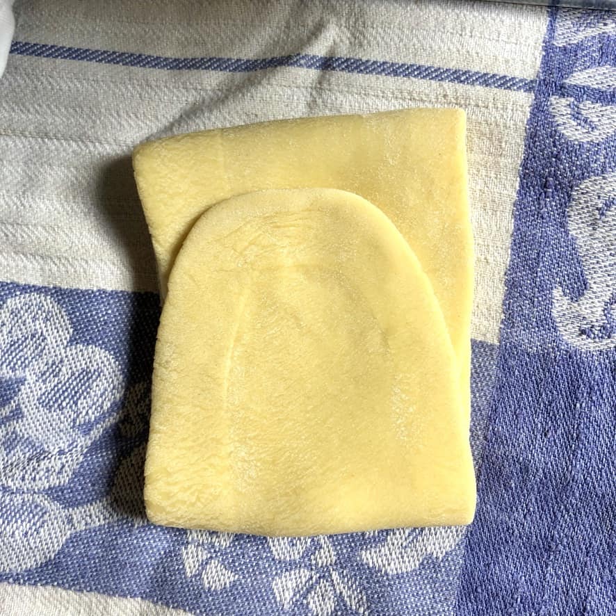 the rolled dough folded over itself like a letter about to be put back through the machine