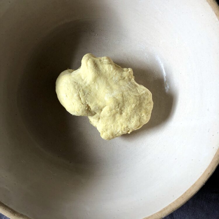 a more yellow and smoother lump of egg noodle dough