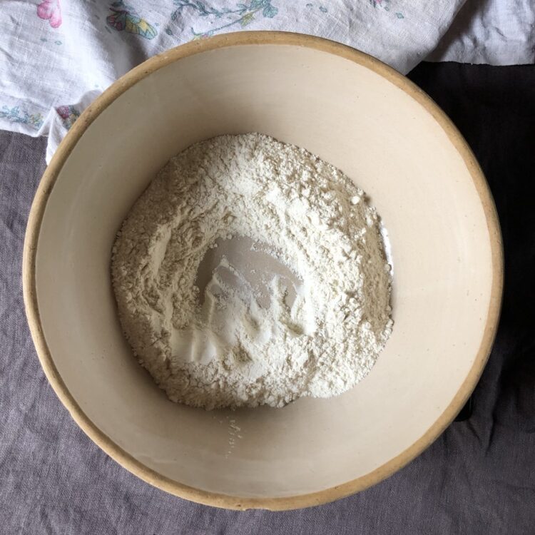 a well made in a mound of flour in my mom's (and great-grandmother's before her) bread bowl