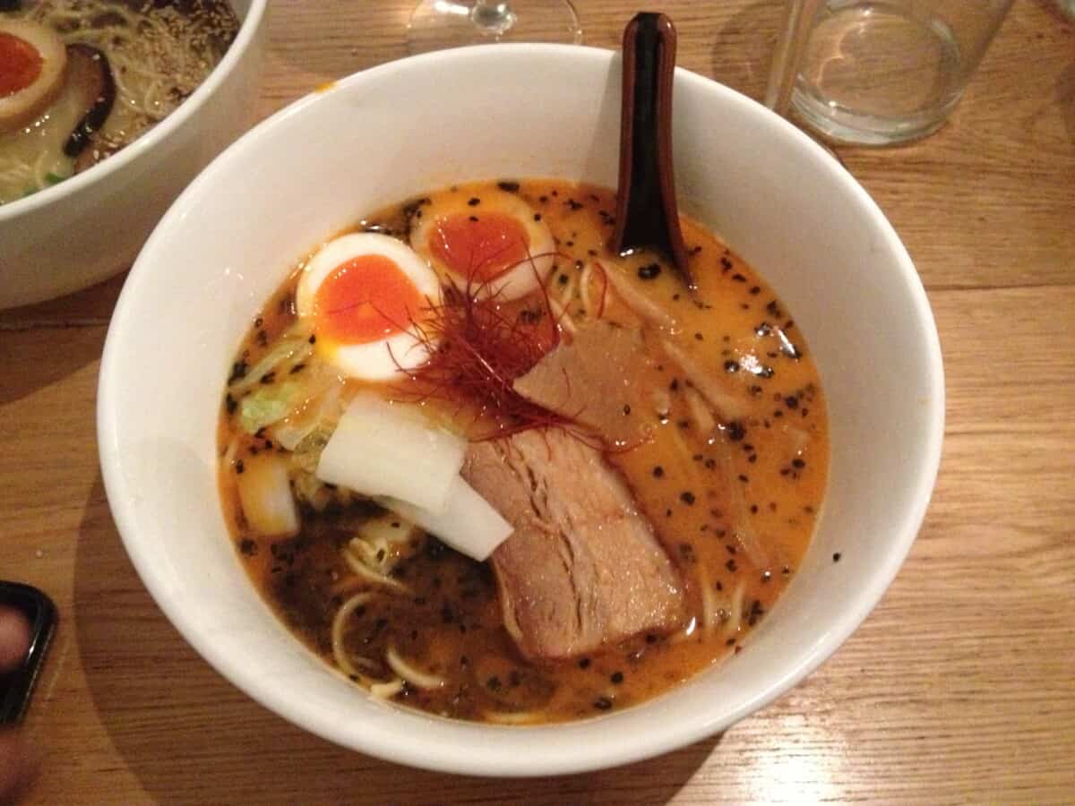 A bowl of ramen from Casa Ramen in Milan with perfectly jammy ramen eggs floating in the soup.