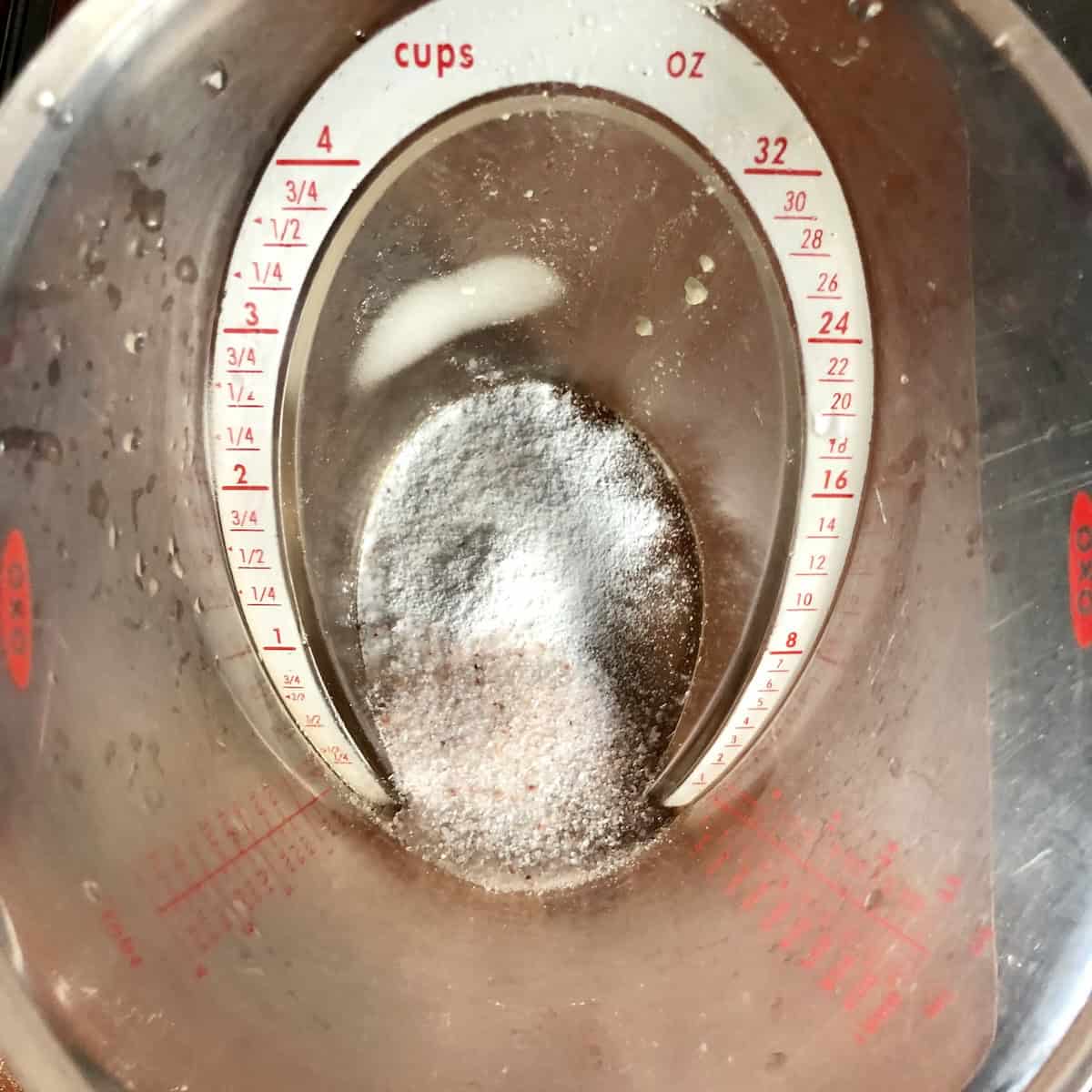 Baked baking soda and salt in measuring cup for making alkaline water for homemade ramen noodles recipe showing ramen ingredients preparation step by step how to make ramen from scratch.