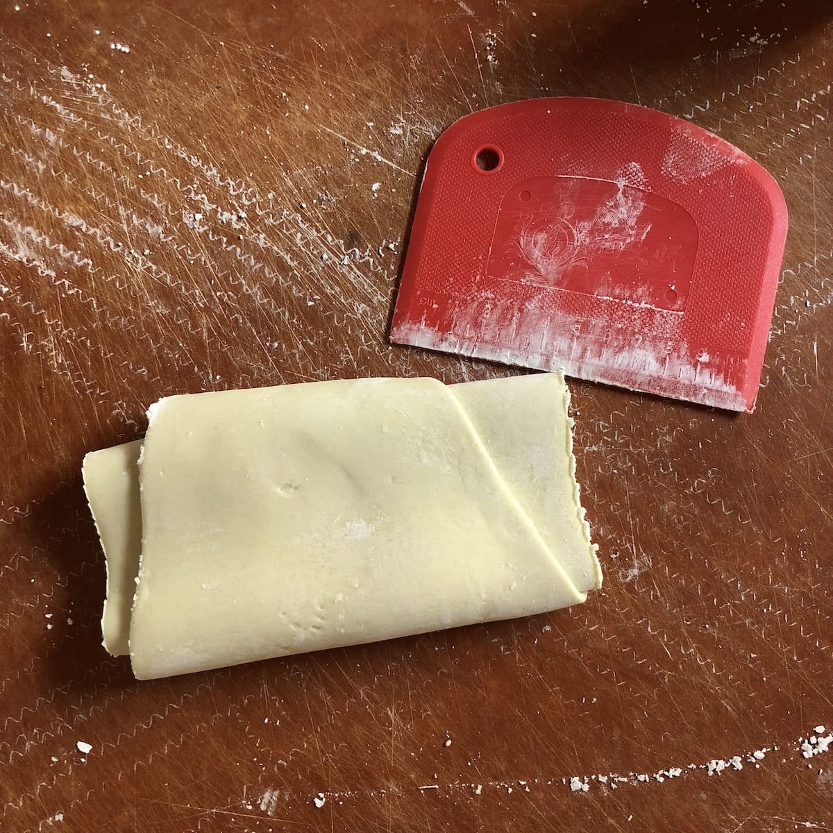 Fresh udon noodles dough rolled up and ready to hand cut showing how to make udon noodles from scratch without pasta machine homemade udon noodles recipe thick udon preparation.